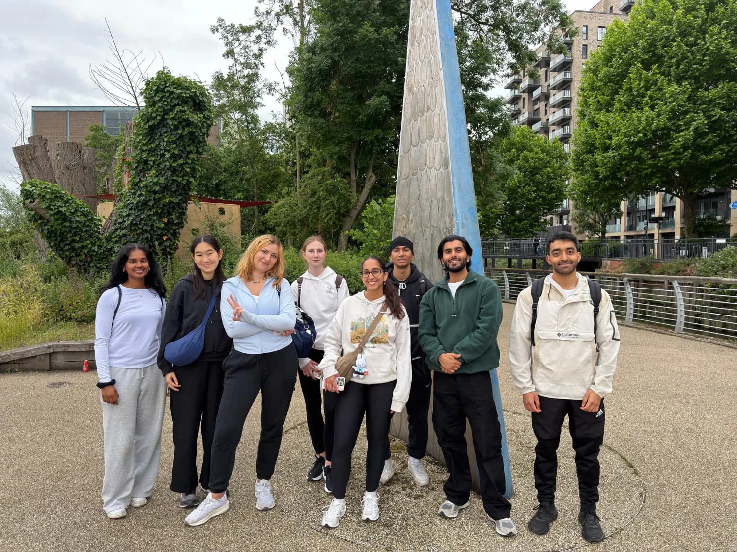 A small group standing together on a riverside path